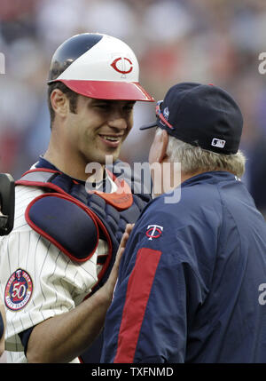 Minnesota Twins catcher Joe Mauer #7 catches a foul ball close to the wall  making the 3rd and final out of the 9th inning in the Twins' baseball game  against the Cleveland