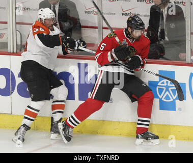 Philadelphia Flyers center Darroll Powe (L) contains Chicago Blackhawks defenseman Brent Sopel during the second period of game 2 of the 2010 Stanley Cup Final at the United Center in Chicago on May 31, 2010.     UPI/Brian Kersey Stock Photo