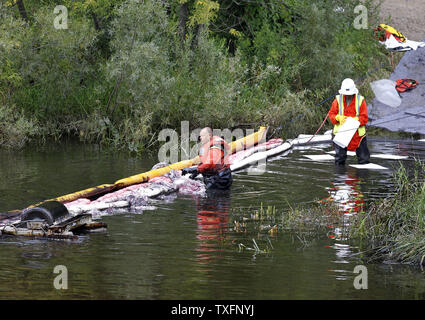 Crews work to clean up the Kalamazoo River near Battle Creek, Michigan on July 30, 2010. A 30-inch-diameter pipeline ruptured sometime between Sunday night and Monday morning, sending between 800,000 and 1 million gallons of oil into nearby Talmadge Creek and the Kalamazoo River.     UPI/Brian Kersey Stock Photo