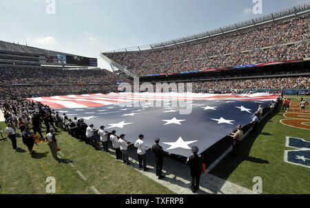 A giant American flag is displayed on the the field during the singing of the 'Star Spangled Banner' before the Chicago Bears Atlanta Falcons game at Soldier Field on September 11, 2011 in Chicago.    UPI/Brian Kersey Stock Photo