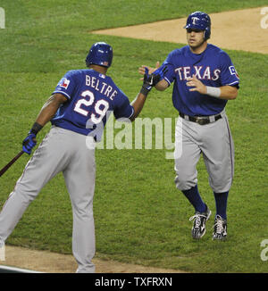 Texas Rangers Adrian Beltre (29) congratulates Ian Kinsler after Kinsler scored on an RBI single hit by Josh Hamilton during the first inning of game 3 of the American League Championship Series at Comerica Park on October 10, 2011 in Detroit, Michigan.    UPI/Brian Kersey Stock Photo