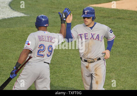 Texas Rangers' Adrian Beltre (29) high-fives Ian Kinsler after Kinsler scored on a sacrifice fly hit by Josh Hamilton during the first inning of game 5 of the American League Championship Series against the Detroit Tigers at Comerica Park on October 13, 2011 in Detroit, Michigan.    UPI/Brian Kersey Stock Photo