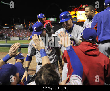 Texas Rangers' Josh Hamilton, left, reaches back to hit Elvis Andrus,  right, on the head with a rosin bag as the two joke around during a  baseball team practice for the World