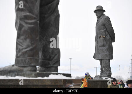 Statues of former Green Bay Packers head coach Vince Lombardi (R) and Packers founder Curly Lambeau stand outside of the main gate of Lambeau Field before the NFC Wildcard Playoff against the San Francisco 49ers in Green Bay, Wisconsin on January 5, 2014.     UPI/Brian Kersey Stock Photo