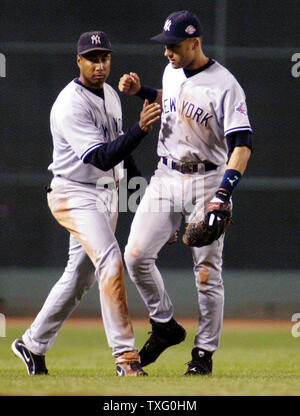 Bernie Williams (left) and Derek Jeter congratulate each other their win over the Boston Red Sox, following Game 5, of the American League Championship Series, at Fenway Park, Tuesday, October 14, 2003, in Boston, Massachusetts. The New York Yankees defeated the Boston Red Sox 4-to-2, giving them a one game lead in the Series. (UPI/STEVEN E. FRISCHLING) Stock Photo