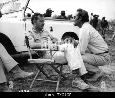 Sam Peckinpah, Charlton Heston  on the set of  Major Dundee  Year: 1965 - USA Stock Photo