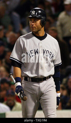 New York Yankees Derek Jeter looks at his bat before stepping into the box  in the first inning against the Philadelphia Phillies in game 2 of the World  Series at Yankee Stadium