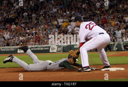 Tampa Bay Devil Rays shortstop Julio Lugo is tagged out by Boston Red Sox third baseman Mike Lowell during the sixth inning at Fenway Park in Boston on May 25, 2006. (UPI Photo/Katie McMahon) Stock Photo