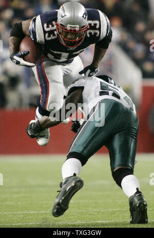 New England Patriot running back Kevin Faulk takes the ball from