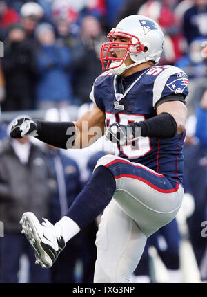 New England Patriots linebacker Junior Seau (55) hoists the AFC Championship  Lamar Hunt trophy after the team defeated the San Diego Chargers 21-12 in  the AFC Championship game at Gillette Stadium in