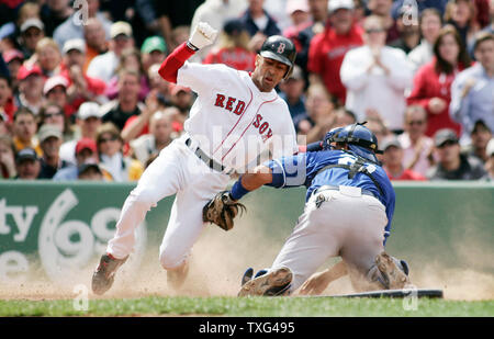 Boston Red Sox's Julio Lugo (L) is tagged out at home by Kansas City Royals catcher Miguel Olivo (21) after a single by Red Sox batter David Ortiz in the fourth inning at Fenway Park in Boston, Massachusetts on May 22, 2008.  (UPI Photo/Matthew Healey) Stock Photo