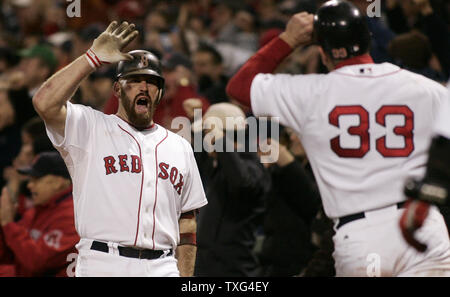 Boston Red Sox's Jason Varitek (left) is congratulated by teammate  Kevin Youkilis (20) in the dugout after Varitek hit a home run against the  Kansas City Royals at Kauffman Stadium, in Kansas