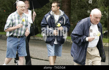 A group of intellectually challenged Workers with the Cape Abilities program of Hyannis, Massachusetts head into the wake of mother Eunice Kennedy Shriver bearing flowers at Our Lady of Victory church in Centerville, Massachusetts on August 13, 2009.  Eunice Shriver, who was the founder of the Special Olympics died early Tuesday in Hyannis, Massachusetts at the age of 88.     UPI/Matthew Healey Stock Photo