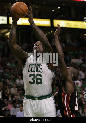 Boston Celtics center Shaquille O'Neal gets off a shot past Miami Heat center Joel Anthony in the first half of the opening night game at the TD Garden in Boston, Massachusetts on October 26, 2010.   UPI/Matthew Healey Stock Photo