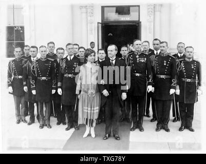 John Calvin Coolidge, 30th President of the USA (1923-1929). President and Mrs Coolidge with military aides outside the White House on l January 1927 after a New Year reception Stock Photo