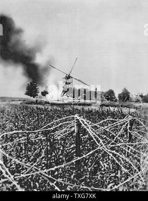 World War I  :  Windmill destroyed by German shellfire. Barbed wire defences in foreground.  France World War I. From 'Le Flambeau', Paris, September 1915. Stock Photo
