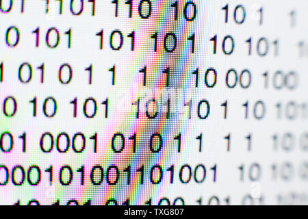 Binary code on a computer screen Stock Photo