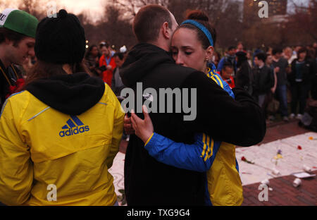 Two people console one another at a candlelight vigil held at Boston Common in Boston, Massachusetts on April 16, 2013.  The vigil is in response to the bombings on Boylston Street near the finish line of the Boston Marathon Monday afternoon killing 3 and injuring 150.    UPI/Matthew Healey Stock Photo