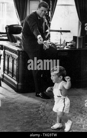 John Fitzgerald Kennedy, 35th President of the United States, serving from 1961 with his son at the White House Stock Photo