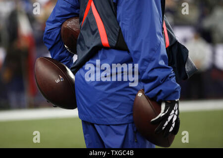 An NFL ball-carrier holds onto three New England Patriots footballs in the second quarter against the Pittsburgh Steelers at Gillette Stadium in Foxborough, Massachusetts on September 10, 2015.  The Patriots defeated the Steelers 28-21.   Photo by Matthew Healey/ UPI Stock Photo