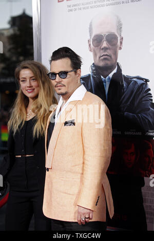 Actor Johnny Depp (R) and wife Amber Heard walk down the red carpet before a special screening of the film 'Black Mass' at the Coolidge Corner Theater in Brookline, Massachusetts on September 15, 2015. Depp plays notorious Boston gangster Whitey Bulger in the upcoming movie.    Photo by Matthew Healey/UPI Stock Photo