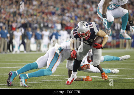 New England Patriots wide receiver Julian Edelman (11) dodges multiple Miame Dolphins defenders on a 16-yard touchdown reception in the fourth at Gillette Stadium in Foxborough, Massachusetts on October 29, 2015.  The Patriots defeated the Dolphoins 36-7.   Photo by Matthew Healey/ UPI Stock Photo