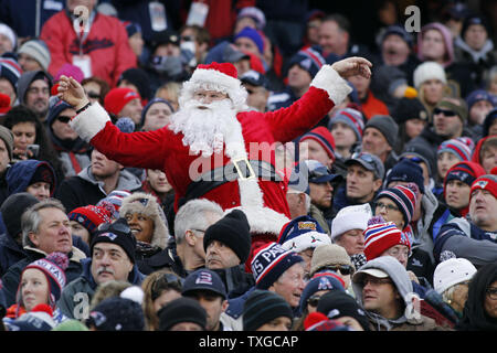 A Tennessee Titans fan is dressed as Santa as he watches the