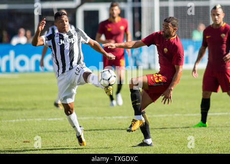 Juventus defender Alex Sandro (12) kicks the ball away from Roma forward Gregoire Defrel (23) in the first half of the International Champions Cup match at Gillette Stadium in Foxborough, Massachusetts on July 30, 2017. Juventus defeated Roma in 6-5 in an overtime penalty kick shoot out.   Photo by Matthew Healey/UPI Stock Photo