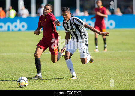 Juventus defender Alex Sandro (12) and Roma forward Gregoire Defrel (23) in the first half of the International Champions Cup match at Gillette Stadium in Foxborough, Massachusetts on July 30, 2017. Juventus defeated Roma in 6-5 in an overtime penalty kick shoot out.   Photo by Matthew Healey/UPI Stock Photo