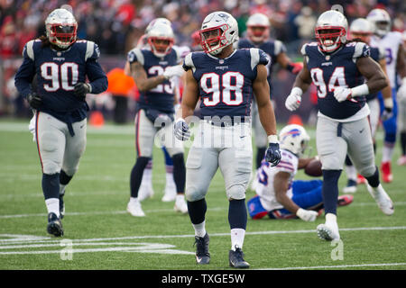 New England Patriots defensive lineman Trey Flowers (98) celebrates a stop of Buffalo Bills running back LeSean McCoy (25) in the third quarter at Gillette Stadium in Foxborough, Massachusetts on December 24, 2017. The Patriots defeated the Bills 37-16. Photo by Matthew Healey/UPI Stock Photo