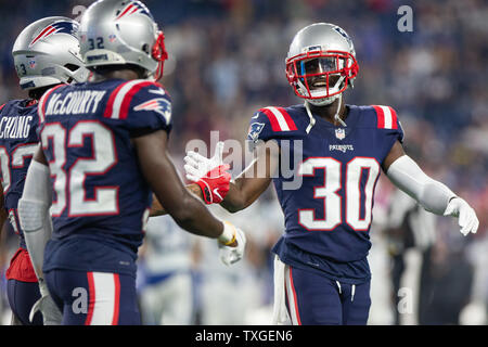 New England Patriots cornerback Jason McCourty (30) gives a high five to safety Patrick Chung (23) and defensive back Devin McCourty (32) after a turnover on downs against the Indianapolis Colts in the fourth quarter at Gillette Stadium in Foxborough, Massachusetts on October 4, 2018. The Patriots defeated the Colts 38-24. Photo by Matthew Healey/UPI Stock Photo