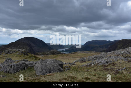 Very dark clouds hanging above Blackbeck Tarn in the Lakes District. Stock Photo