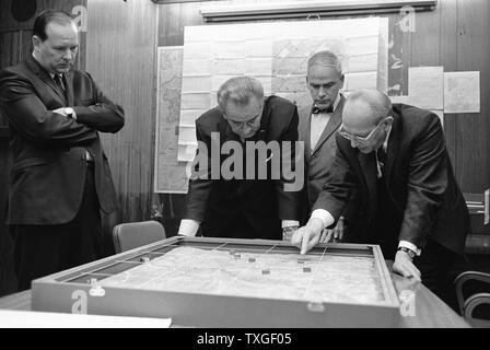 White House Situation Room. Walt Rostow shows President Lyndon Johnson, options for a military attack on a site in Vietnam during the Vietnam War 1968 Stock Photo