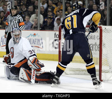 New York Islanders goalie Rick DiPietro (39) makes a pad save and keeps Buffalo Sabres right wing Maxim Afinogenov (61) from scoring on the rebound in the second period at the HSBC Arena in Buffalo, New York on April 14, 2007.  The Islanders defeated Buffalo 3-2 to even the series, one game apiece. (UPI Photo/Jerome Davis) Stock Photo
