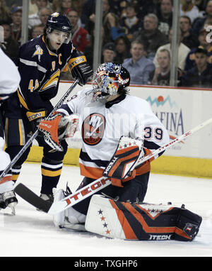 New York Islanders goalie Rick DiPietro (39) makes a glove save as Buffalo Sabres center Daniel Briere (48) looks for a rebound in the second period at the HSBC Arena in Buffalo, New York on April 14, 2007.  The Islanders defeated Buffalo 3-2 to even the series, one game apiece. (UPI Photo/Jerome Davis) Stock Photo