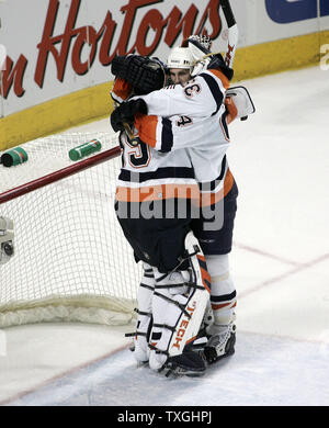 New York Islanders goalie Rick DiPietro (39) is given a huge by teammate Ryan Smyth (R) after his performance in the third period against the Buffalo Sabres at the HSBC Arena in Buffalo, New York on April 14, 2007.  The Islanders defeated Buffalo 3-2 to even the series, one game apiece. (UPI Photo/Jerome Davis) Stock Photo