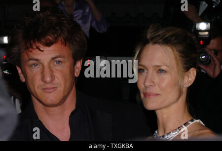 Sean Penn and his wife Robin Wright-Penn pose for photographers on the red carpet before the gala screening of 'The Assassination of Richard Nixon' at the Palais des Festivals May 17, 2004 during the Cannes Film Festival in Cannes, France. (UPI Photo/Christine Chew) Stock Photo