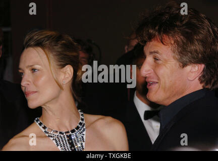 Sean Penn and his wife Robin Wright-Penn pose for photographers on the red carpet before the gala screening of 'The Assassination of Richard Nixon' at the Palais des Festivals May 17, 2004 during the Cannes Film Festival in Cannes, France. (UPI Photo/Christine Chew) Stock Photo