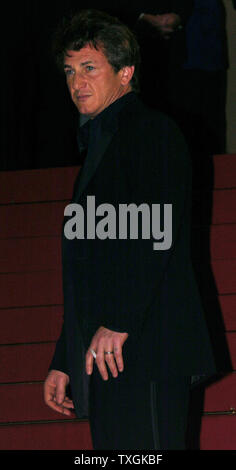 Sean Penn poses for photographers on the red-carpeted steps leading to the Palais des Festivals before the gala screening of 'The Assassination of Richard Nixon' May 17, 2004 during the Cannes Film Festival in Cannes, France. (UPI Photo/Christine Chew) Stock Photo