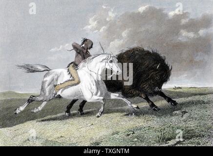 North American Indian, mounted on horse, hunting buffalo (bison) with a bow and arrow.  1861  Hand-coloured engraving Stock Photo