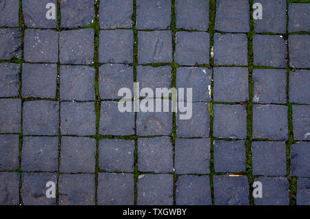 Old cobblestone tile texture in old town. City pavement background. Abstract granite stone brick pattern. Street sidewalk texture Stock Photo
