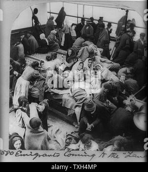 Immigrants, problably Russian or Polish, on board a boat approaching New York, USA Stock Photo