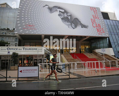 An early morning jogger passes the Palais des Festivals during the 66th annual Cannes International Film Festival in Cannes, France on May 18, 2013.   UPI/David Silpa Stock Photo