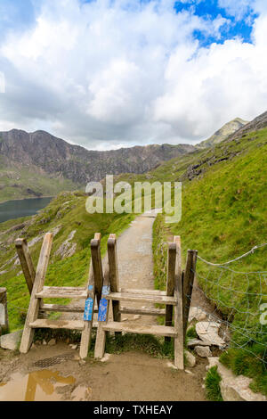 The two stiles on the Pyg Track at Bwlch y Moch with Snowdon beyond, Snowdonia National Park, Gwynedd, Wales, UK Stock Photo
