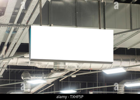 Mock up. Horizontal rectangular white empty signage, information board inside in shopping mall, store Stock Photo