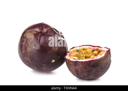 Whole and half passion fruit on white background. Passion fruit seeds and pulp. Close up. Copy space Stock Photo