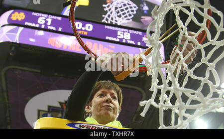 Notre Dame head coach Muffet McGraw cuts down the final piece of the net after defeating Mississippi State 61-58 in the Women's D1 Final Four championship basketball game on April 1, 2018 in Columbus, Ohio. Photo by Aaron Josefczyk/UPI Stock Photo