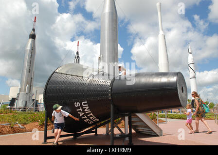 Tourists inspect a Gemini space vehicle at the Rocket Garden at the Kennedy Space Center Visitors Center on July 3, 2006.  The rockets on display are from the early days of the U.S. space program. The Space Shuttle Discovery launch has been delayed to at least July 4, 2006.    (UPI Photo/Pat Benic) Stock Photo