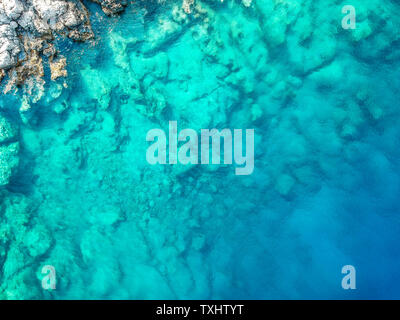 Into the deep 2. View from above of clear aqua blue sea with rock formations underneath. Great background image. Turkey Stock Photo