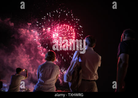 (190625) -- ATHENS, June 25, 2019 (Xinhua) -- People view a fireworks show for the opening of the Summer Nostos (Homecoming) Festival at the Stavros Niarchos Foundation Cultural Center in Athens, Greece, June 23, 2019. Greek artist Alkistis Protopsalti, one of the most acclaimed and popular singers in the past four decades in Greece, sang a Chinese song during her performance in a festival in Athens on Sunday evening, enthralling the audience. TO GO WITH 'Feature: Greek artist Alkistis Protopsalti sings Chinese song, enthralling audience of Athens festival' (Xinhua/Lefteris Partsalis) Stock Photo